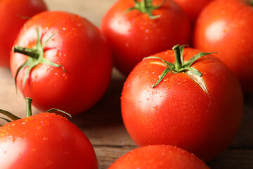 Fresh ripe tomatoes on wooden table, closeup