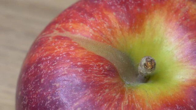 The big red apple is spinning, close-up video. Video in full hd format. Macro image of apple.