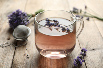 Fresh delicious tea with lavender in glass cup on wooden table