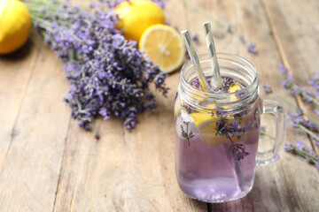 Fresh delicious lemonade with lavender in masson jar on wooden table. Space for text