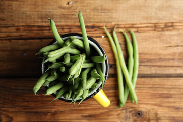 Fresh green beans on wooden table, flat lay