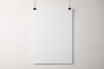 White blank poster hanging near light wall
