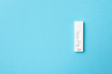 Test cartridge from the kit for self-testing for the antigen of the covid-19 virus, blue background, copy space.