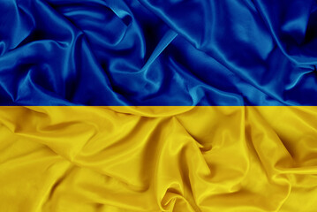 Beautiful dynamic blue-yellow flag of Ukraine on a fabric background, wavy flag of Ukraine