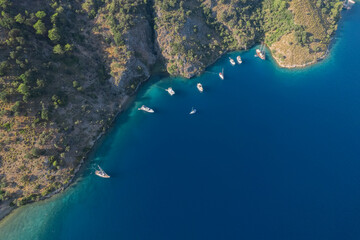 sarsala beach bay dalaman Mediterranean bay with hills and pine forest blue water and boats