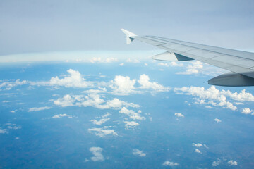 Airplane Window View with Airplane wing and Blue Sky