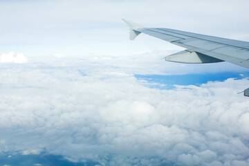 Airplane Window View with Airplane wing and Blue Sky