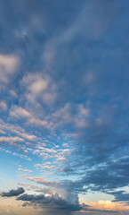 Fantastic clouds at sunrise, vertical panorama