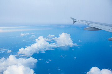 Airplane Window View with Airplane wing and Blue Sky