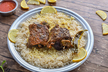 Arabian mandi meat with lemon slice and sauce served in dish top view of middle east food