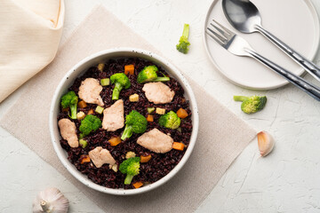 Healthy fried riceberry rice (brown jasmine rice) with chicken breast and broccoli carrot in white plate.Top view