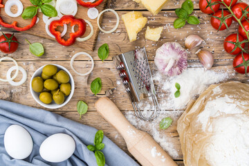 ingredients for cooking pizza on a wooden table, the process of cooking dough and homemade pizza