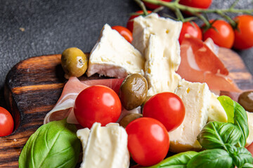 meat platter or cheese platter jamon, cheese, olives healthy meal food snack on the table copy space food background rustic top view