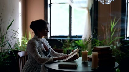 historical atmosphere of noble estate in 19 century, woman is reading book in ancient library