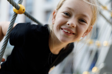 Portrait of a happy girl on the playground, carefree and active lifestyle.