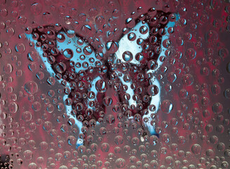 Burgundy-blue spheres are located against the vinous background with maroon-blue butterfly silhouette. Abstract fantasy. 3D render. 