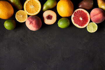 Fresh ripe fruits. Food concept background. Healthy organic food, diet concept. Top view on black board, copy space.