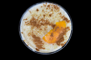 Delicious rice pudding with cinnamon and with a touch of orange, presented in a bowl. Zenith view.