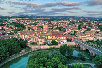 Fototapeta na wymiar Old italian city Umbertide near Tevere river with cloudy sky and sunset light