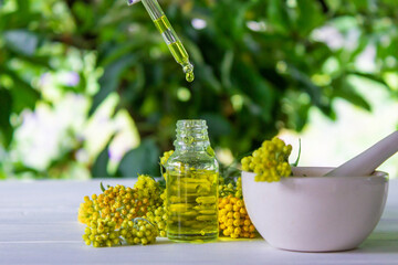 tansy essential oil in a beautiful bottle on the table