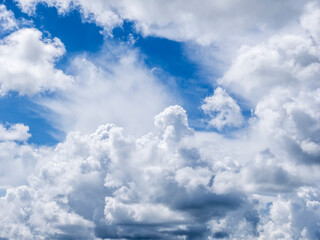 Naklejka na ściany i meble Overhead white dramatic clouds in a blue sky