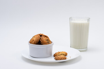 Cookies or biscuits and glass of milk for breakfast or snacks, a healthy concept lifestyle with copy space for text isolated on white background