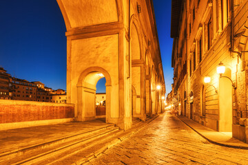 Illuminated Ponte Vecchio Bridge with Reflection in Arno River at Dusk, Florence