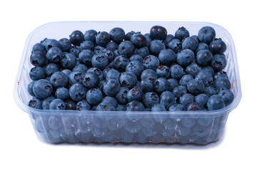 Blueberries in a plastic container isolated on white background.
