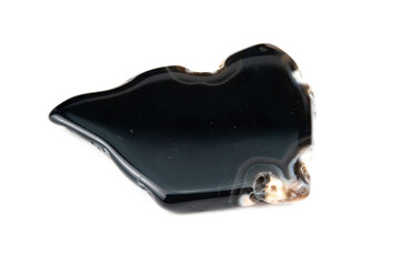 A plate of polished black mineral agate with small yellowish patches