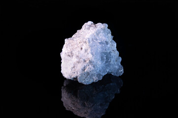A piece of the raw mineral celestite with a light crystalline surface