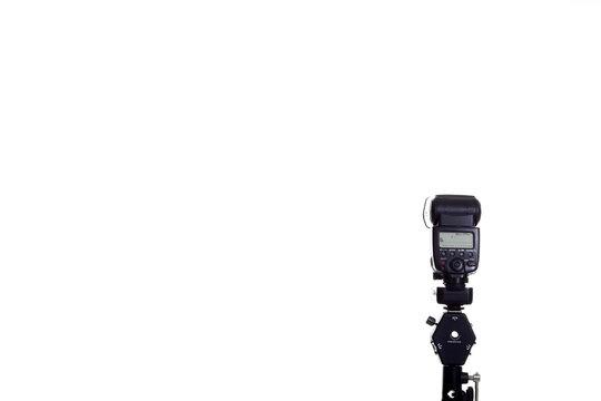 Speedlite flash on the white background and light stand