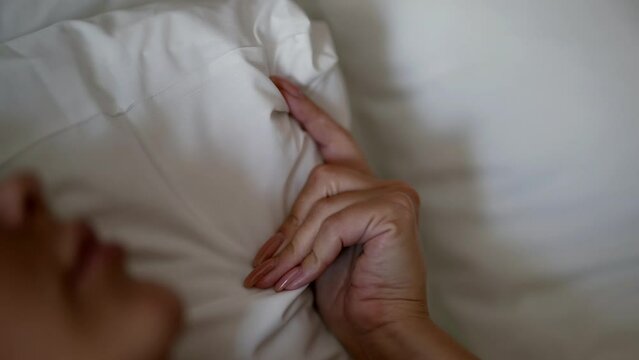 woman in bed during sex, closeup view of hand and face, exciting and erotic moving, sensual fantasy