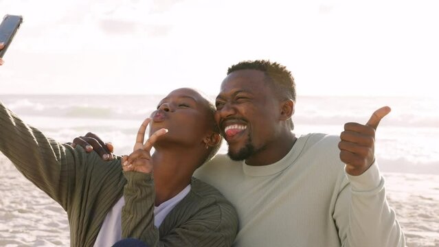 Silly beach selfie, couple happy at sea and smartphone technology. Miami ocean sunset, holiday love and vacation moments together. Black woman photograph sunrise sky, man smile and picture happiness