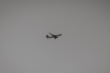 plane takes off in the distance, black and white photo