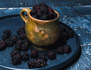photography of fresh blackberries in an artisan clay cup from guatemala
