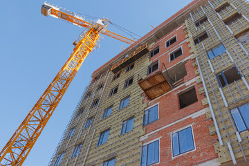 Construction of a residential building. Part of urban real estate and architecture. Facade of a residential building.