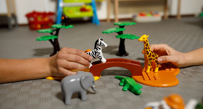 children's game with animal figurines, savannah, hands