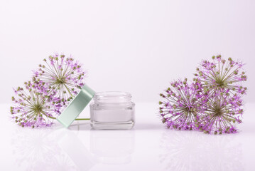 cosmetic cream with flowers on a white background. Face and hand skin care. Natural cosmetic