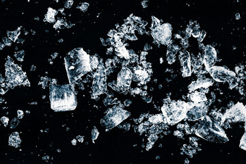 Ice cubes crush on black background. Chill backdrop.