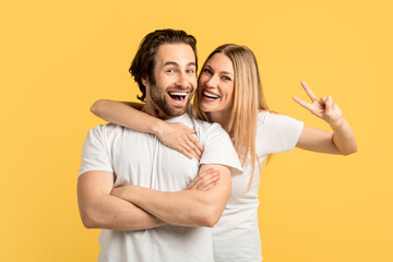 Cheerful millennial caucasian man with stubble and lady in white t-shirts with open mouths have...