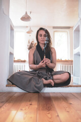 woman practicing yoga lesson, breathing, meditating, doing Padmasana exercise