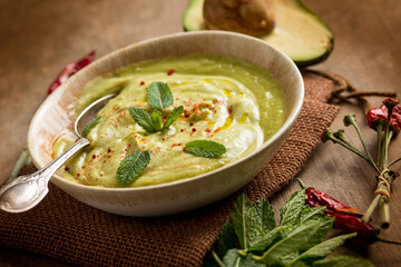 avocado soup with mint leaf and hot chili pepper