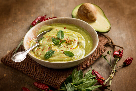 avocado soup with mint leaf and hot chili pepper