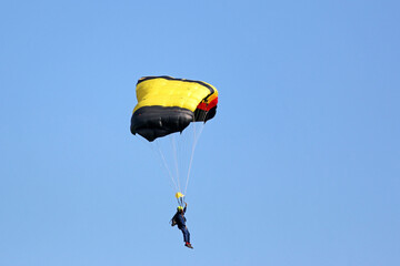 	
Skydiver flying wing in a blue sky	
