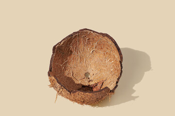 Empty coconut shell on yellow pastel background. Food concept.