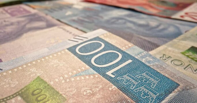 Swedish krona bills. Many swedish money banknotes. Close up shot. Slow motion. Currency of Sweden. Inflation. Finance. Pile of cash kronas. Economy. Banking. Money concept. Macro shot