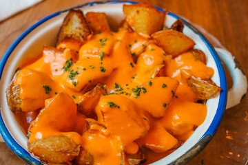 Patatas bravas, spicy potatoes, a typical Spanish dish with fried potato cubes and a spicy garlic sauce. Bilbao typical pintxo.