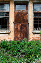 Rusty metal door of abandoned building