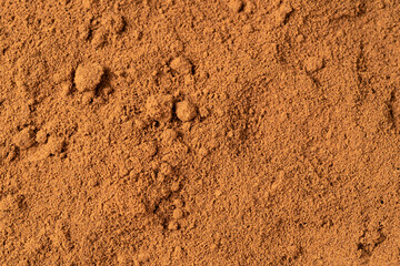Top view of roasted coffee beans for background and texture. A pile of roasted and ground coffee beans can be used as a background and texture.