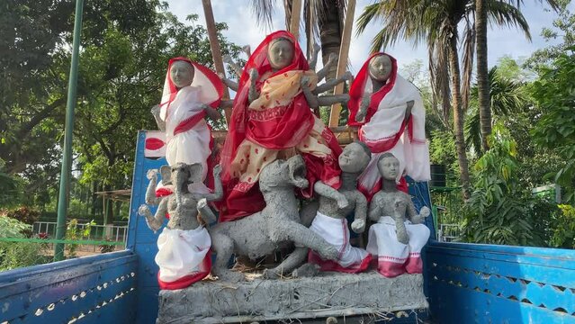 Hindu Goddess Maa Durga Puja in a white and red saree.